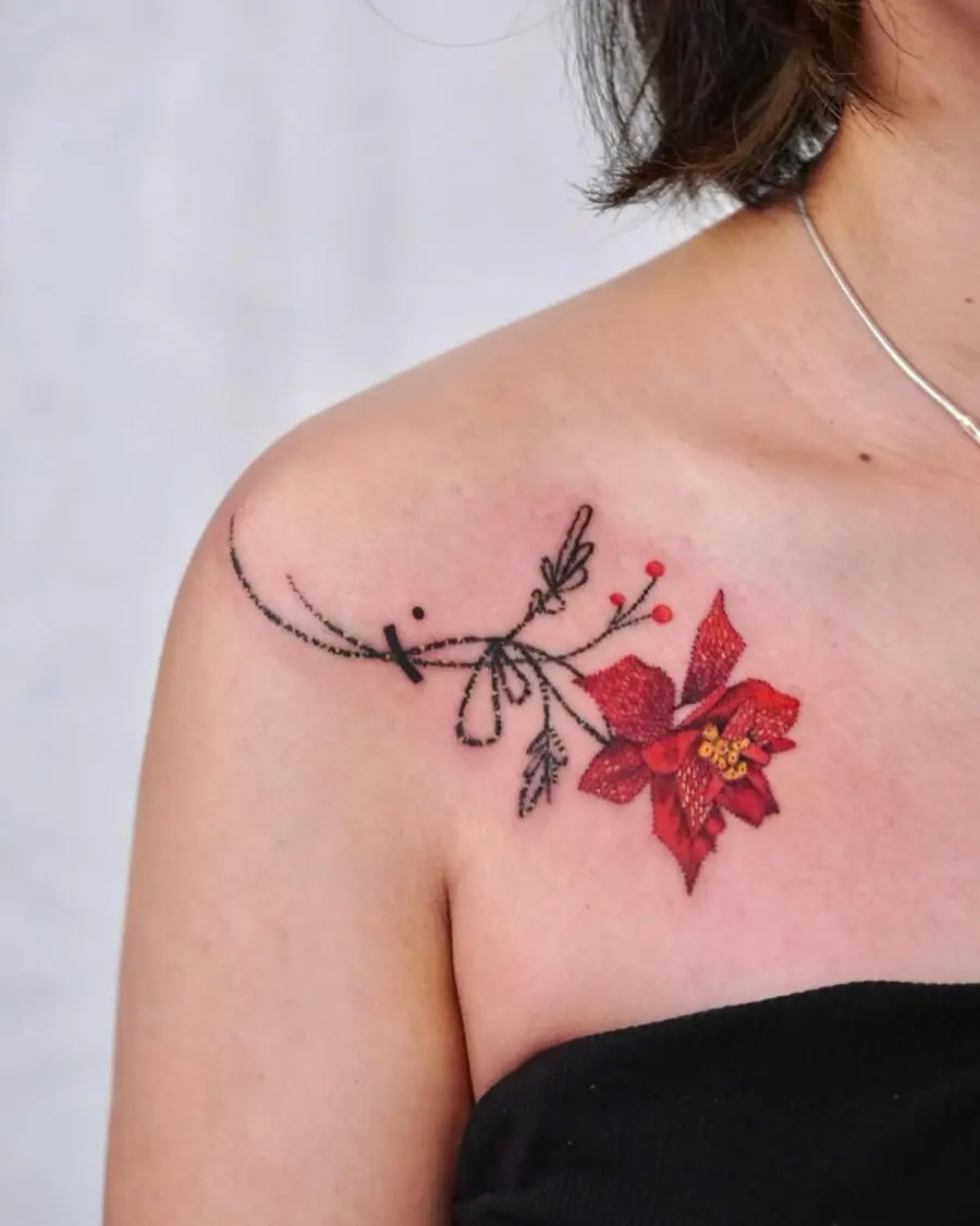 Vivid poinsettia tattoo accentuates shoulder elegance
