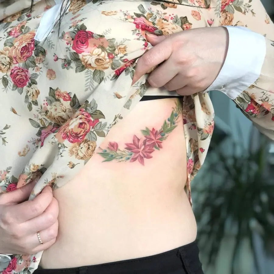 Elegant poinsettia tattoo on side body