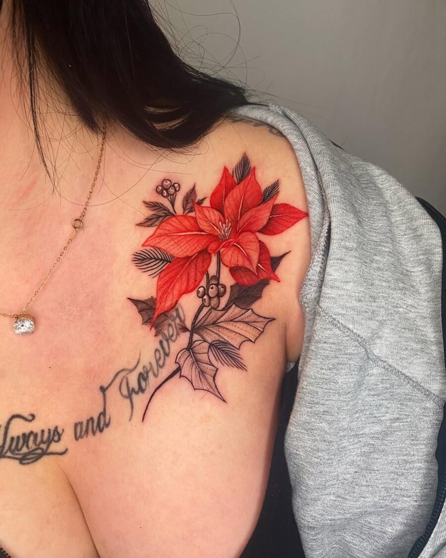 Vibrant poinsettia tattoo enhancing shoulder elegance