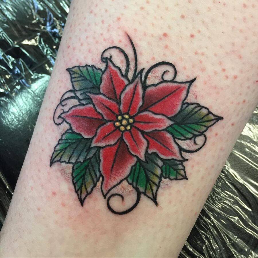 Vibrant Poinsettia Tattoo with Swirling Details