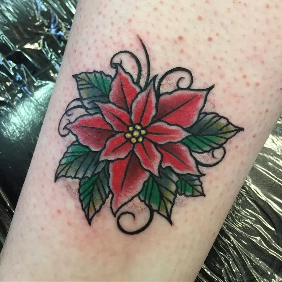 Vibrant Poinsettia Tattoo with Swirling Details