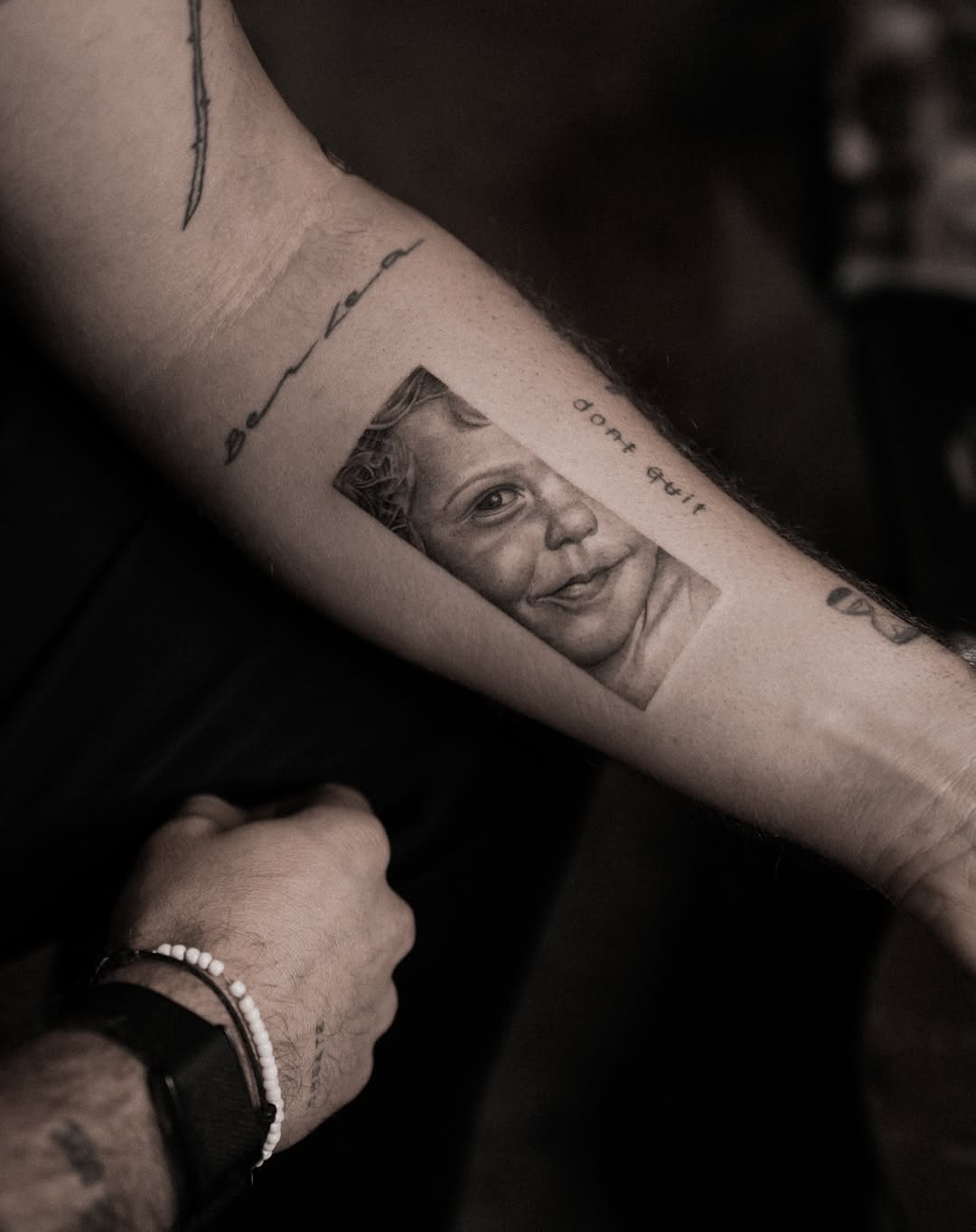 Unique portrait tattoo capturing a child's smile