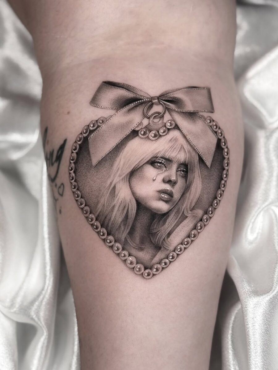 Intricate portrait tattoo with ribbon and pearls