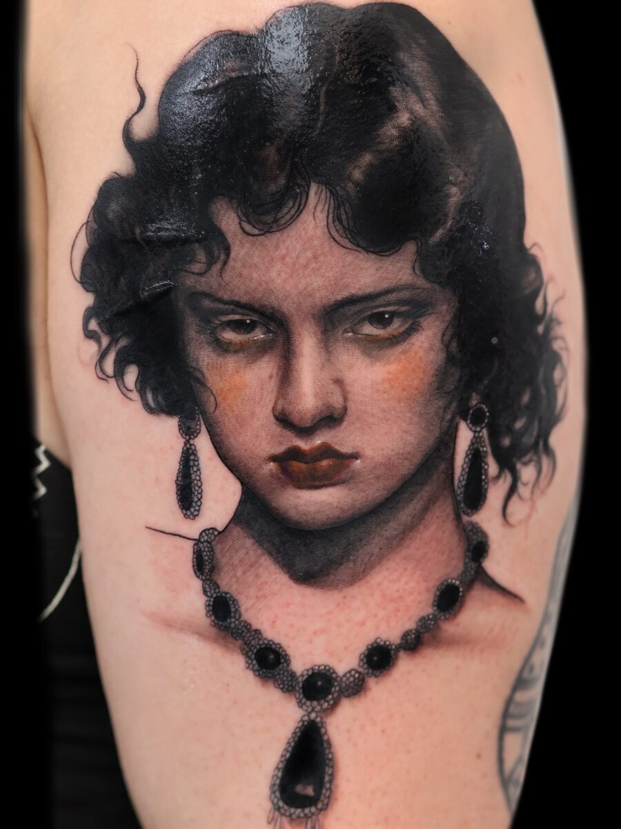 Intricate vintage woman portrait tattoo on skin