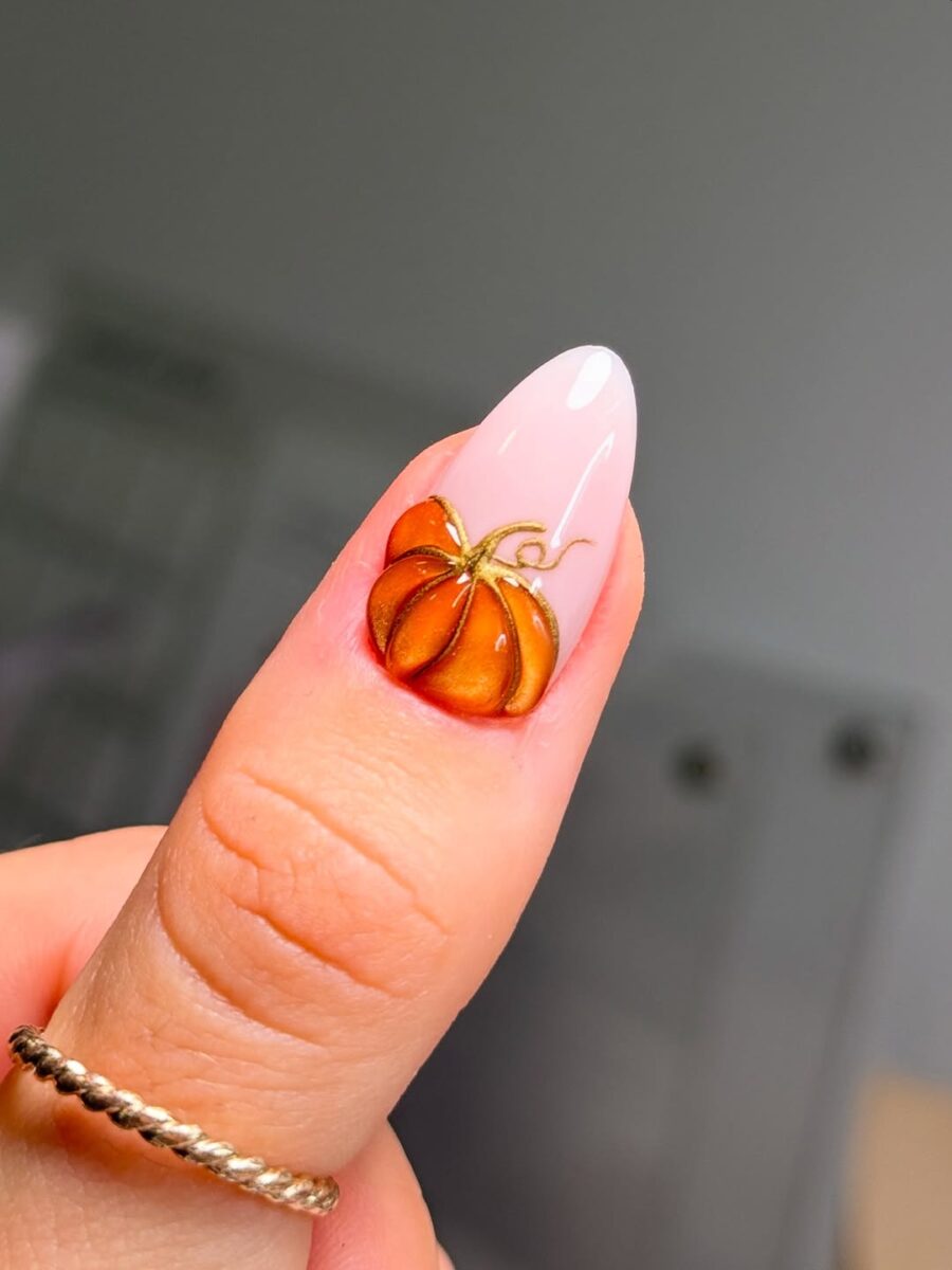 Charming pumpkin design on elegant nail tip