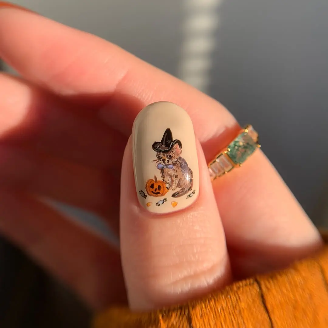 Charming Halloween-themed pumpkin nail art design