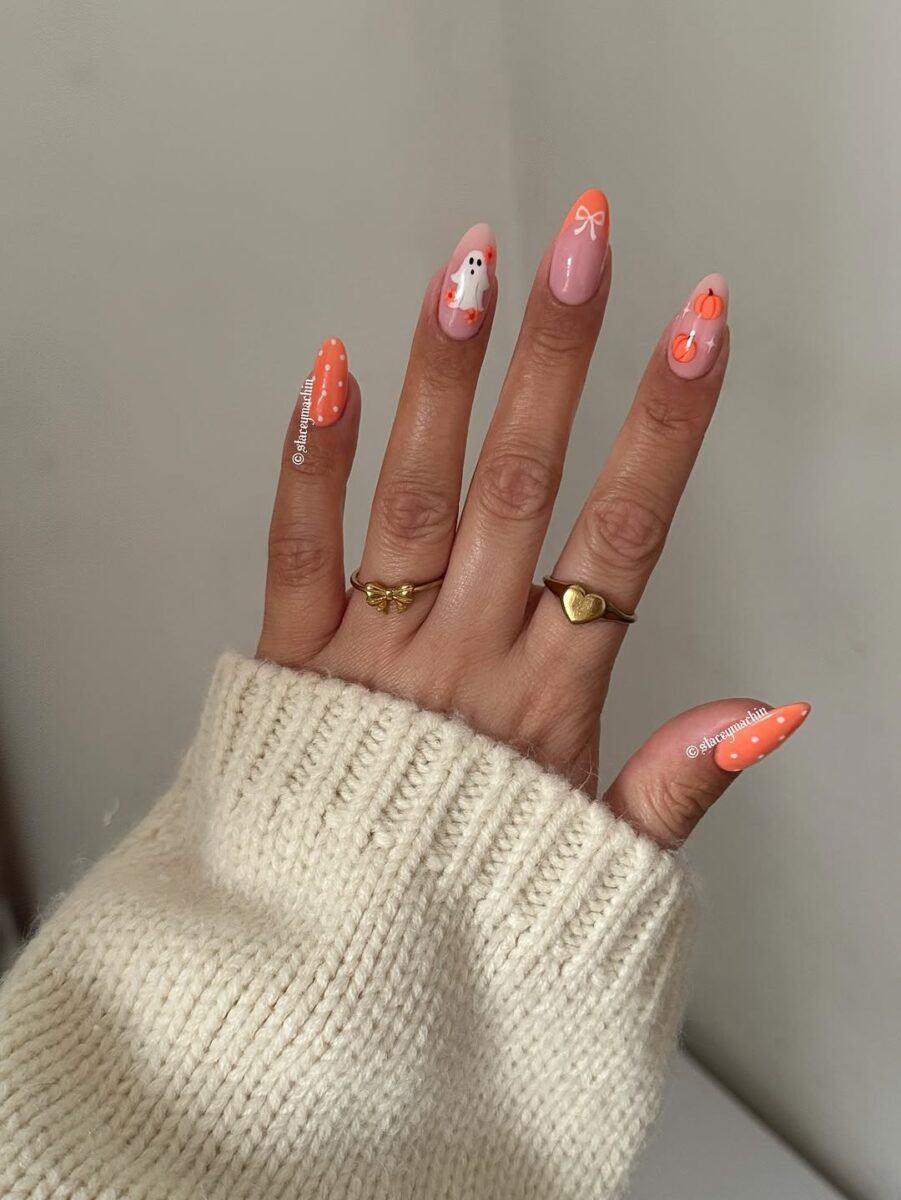 Charming pumpkin nails with playful ghost accents
