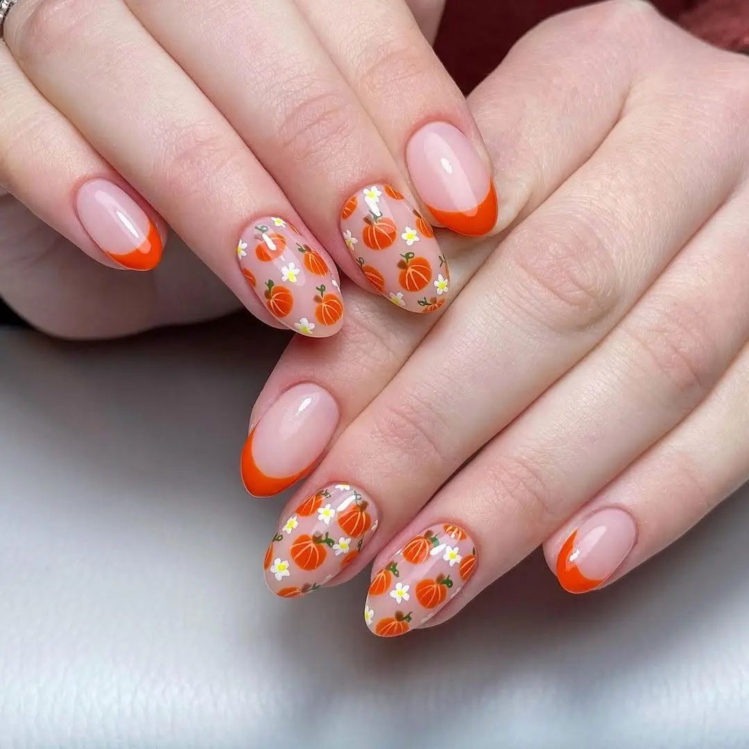 Charming pumpkin-themed nails for fall vibes