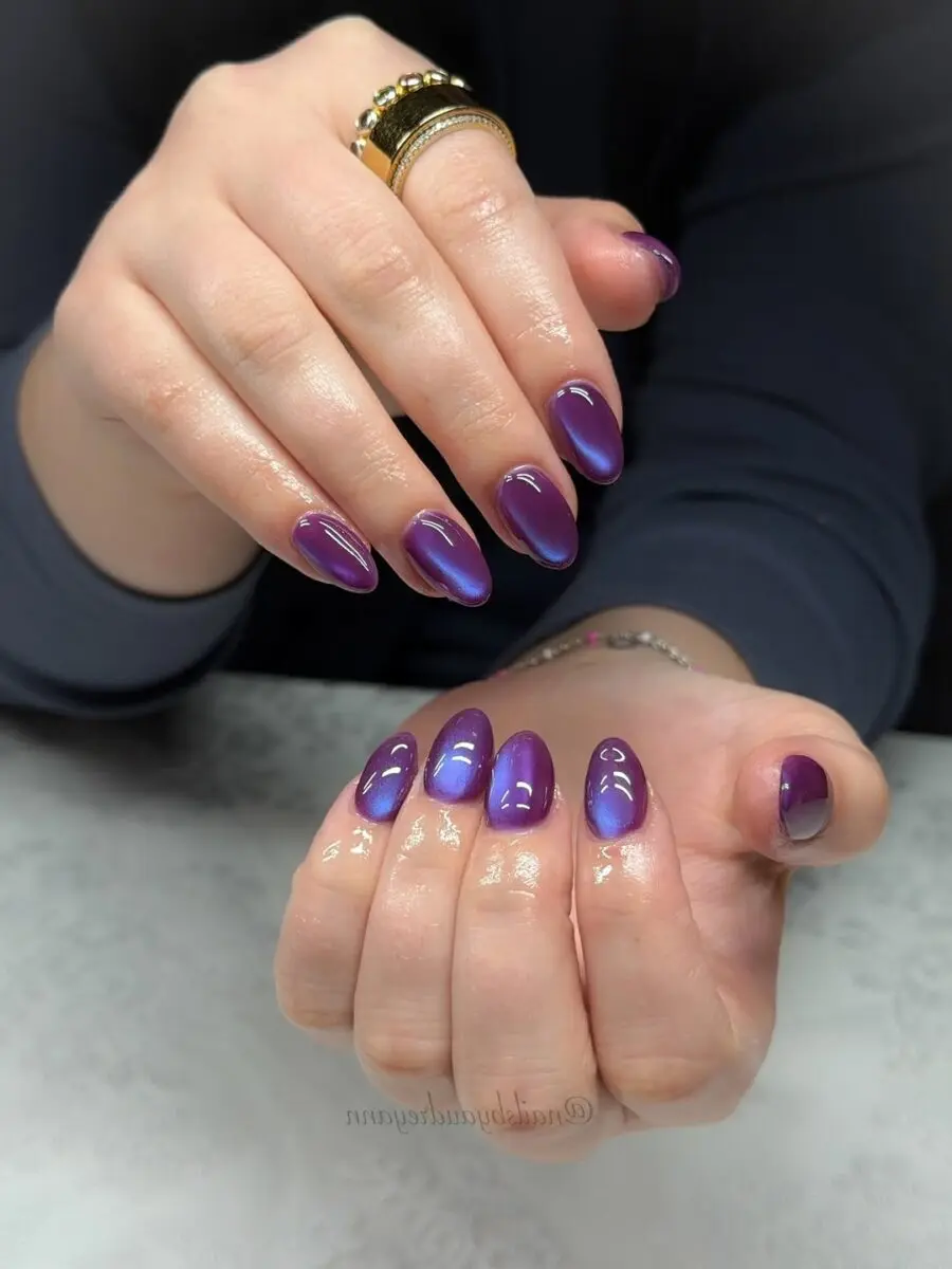 Vibrant purple cat eye nail design