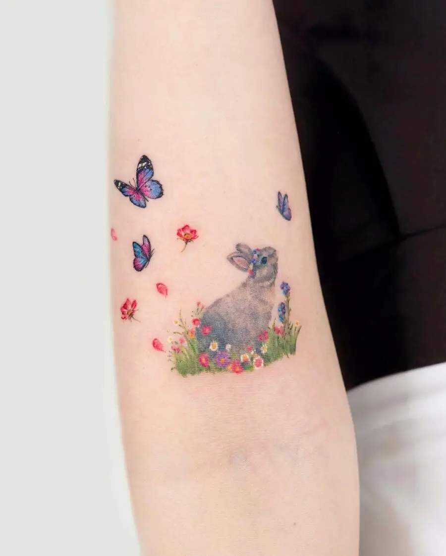 Charming rabbit tattoo surrounded by nature's beauty