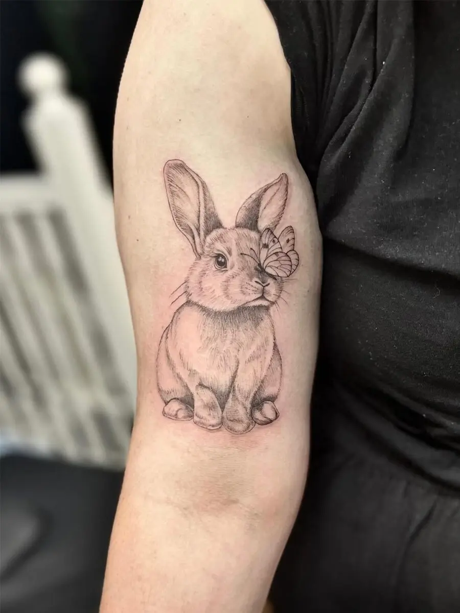 Adorable rabbit tattoo with butterfly detail