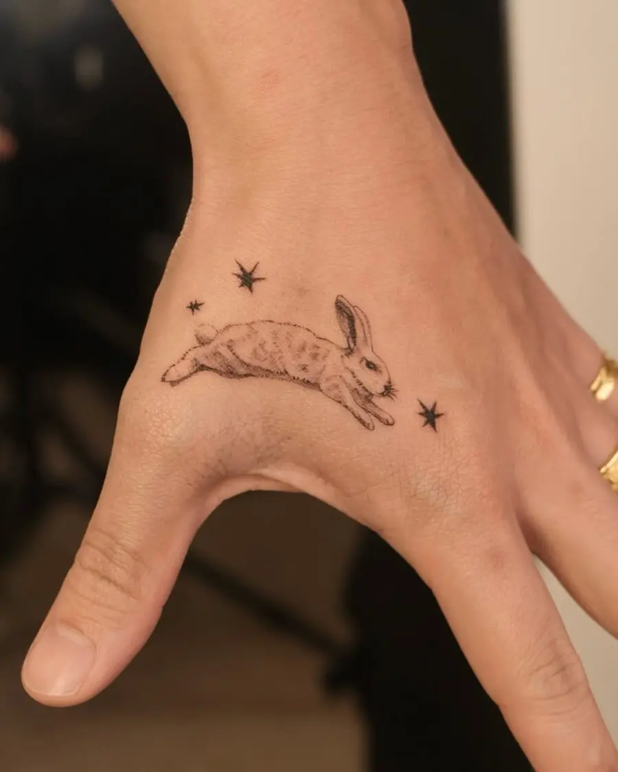 Whimsical rabbit tattoo with celestial accents