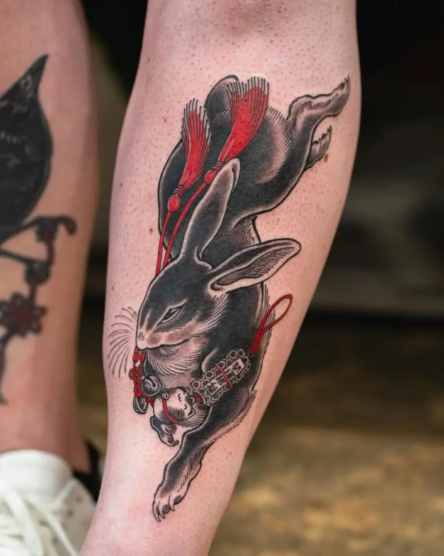 Dynamic rabbit tattoo with vibrant red accents