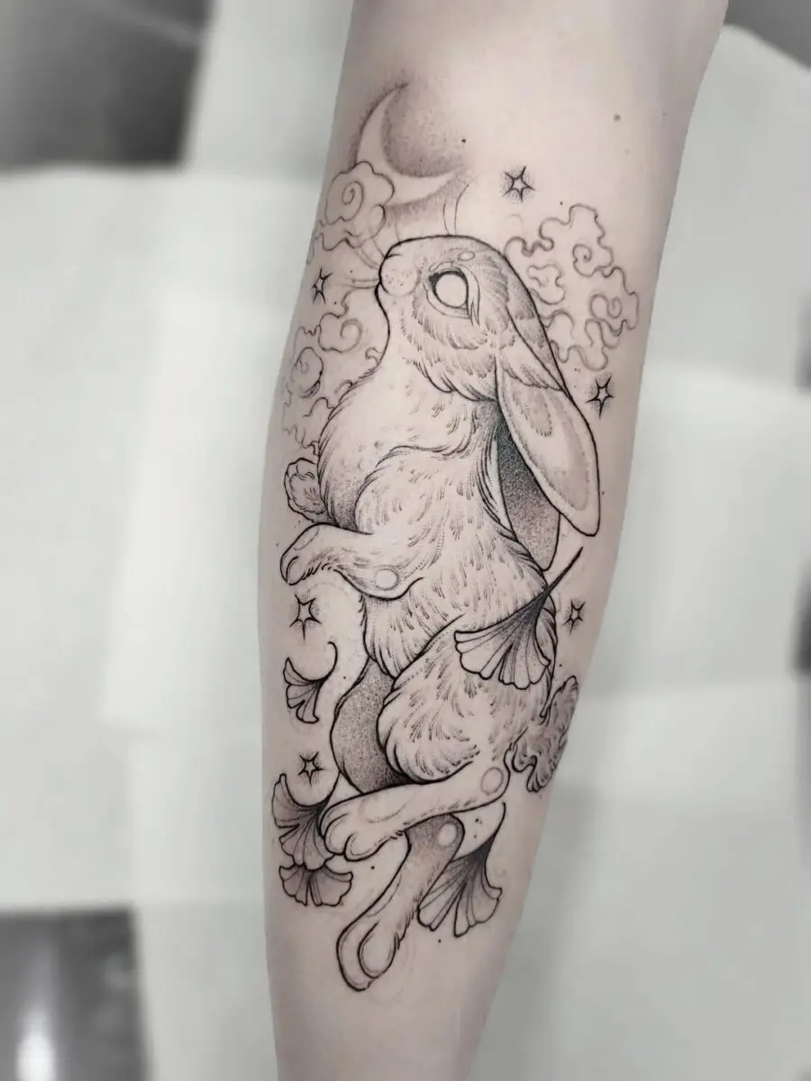 Whimsical rabbit tattoo with nature elements
