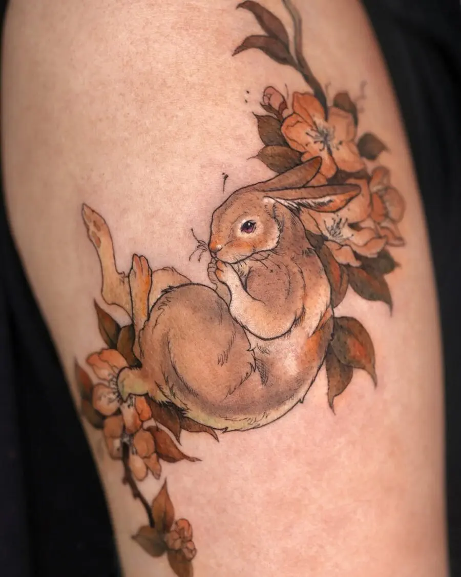 Whimsical rabbit tattoo surrounded by blooms