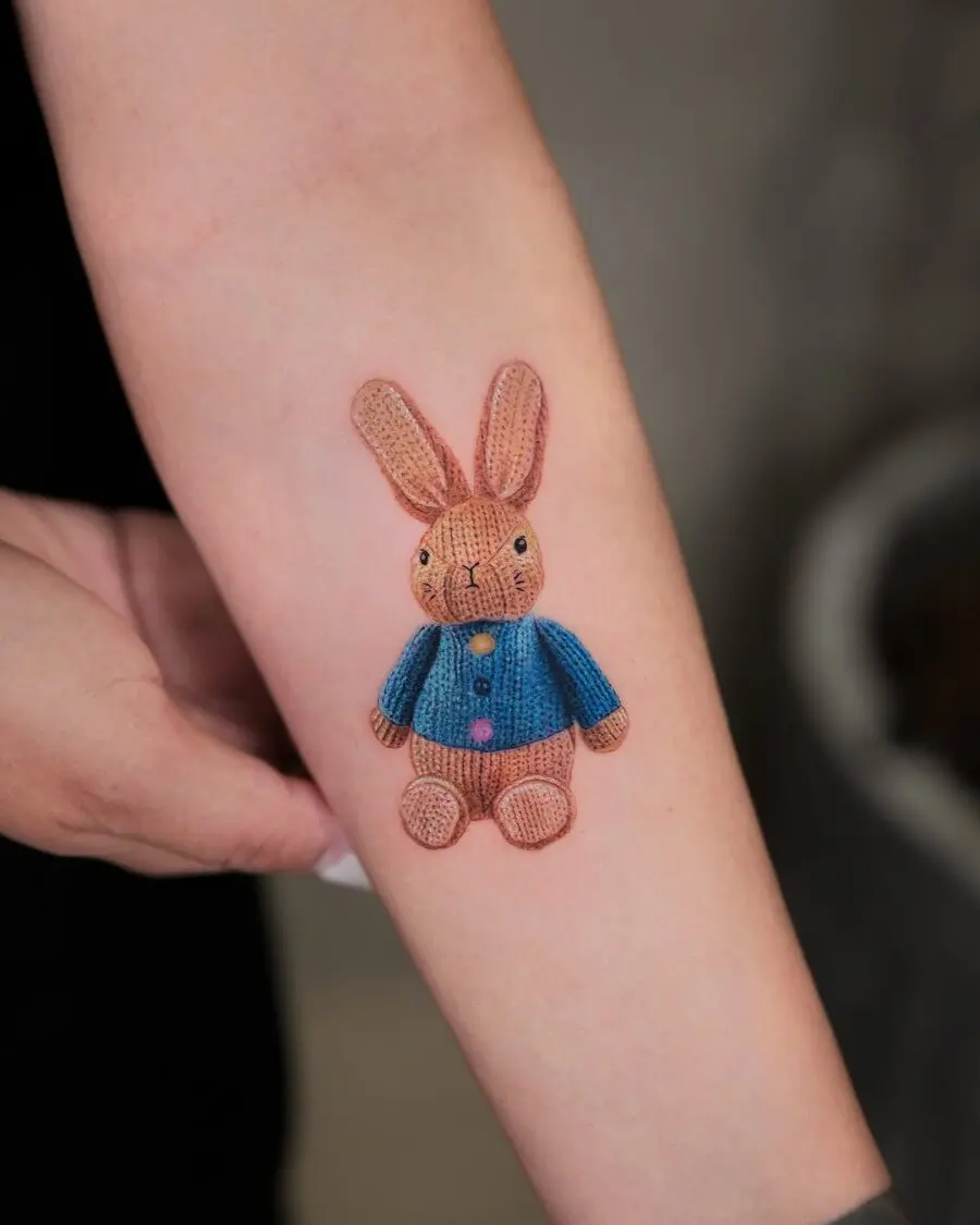 Cute rabbit tattoo with knitted texture