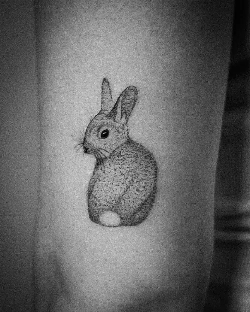 Charming black and white rabbit tattoo design