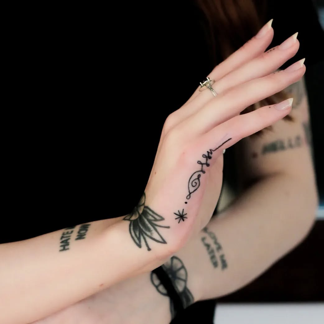 Elegant side hand tattoo with floral elements