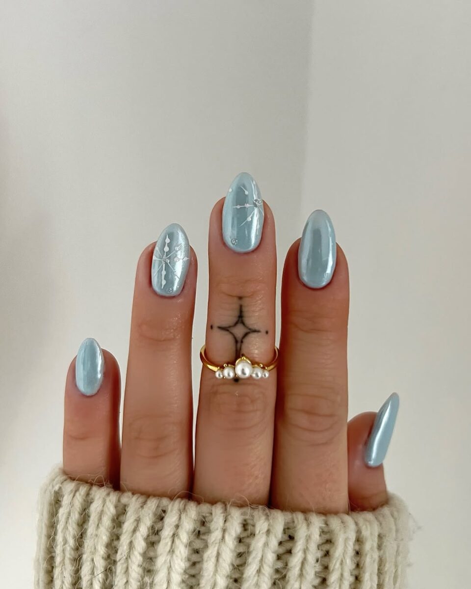 Elegant light blue snowflake nail design