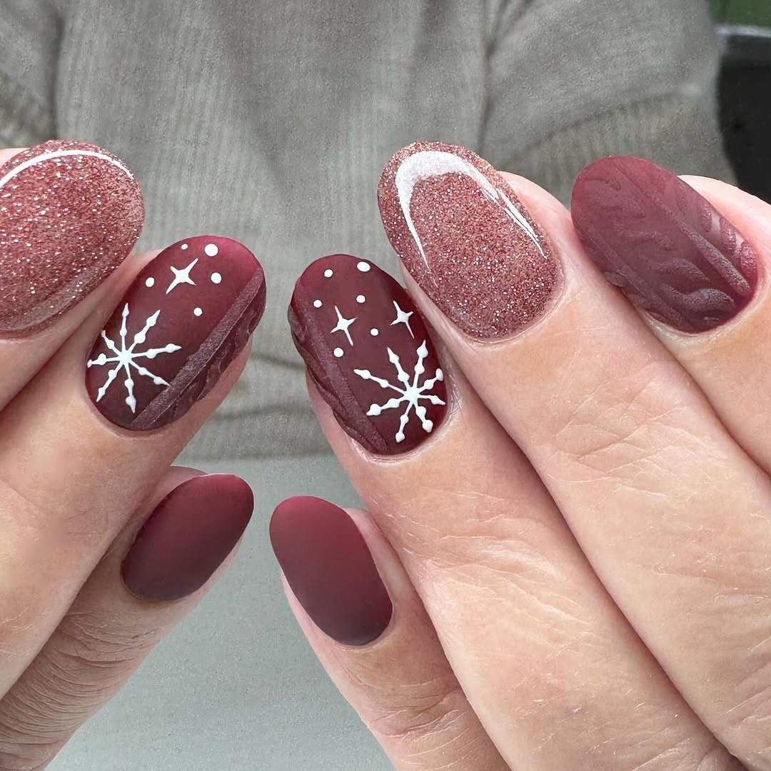 Elegant maroon nails with snowflake accents