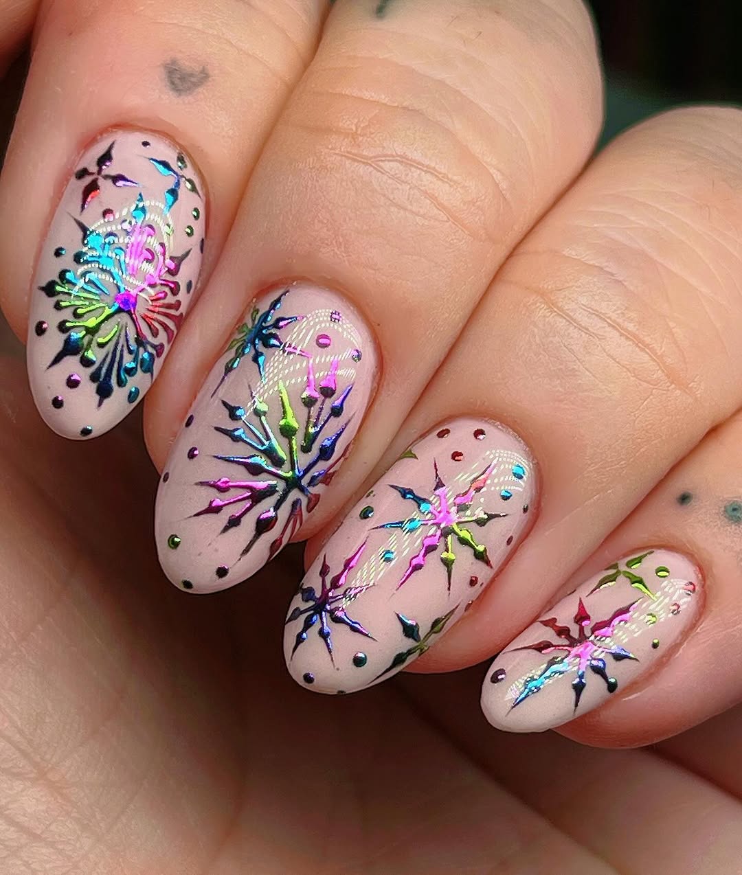 Vibrant snowflake nail art for winter vibes