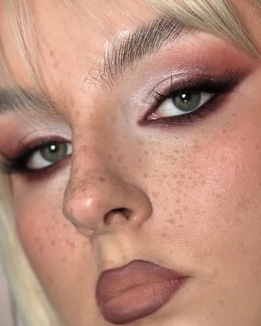 Chic soft grunge makeup with freckled charm