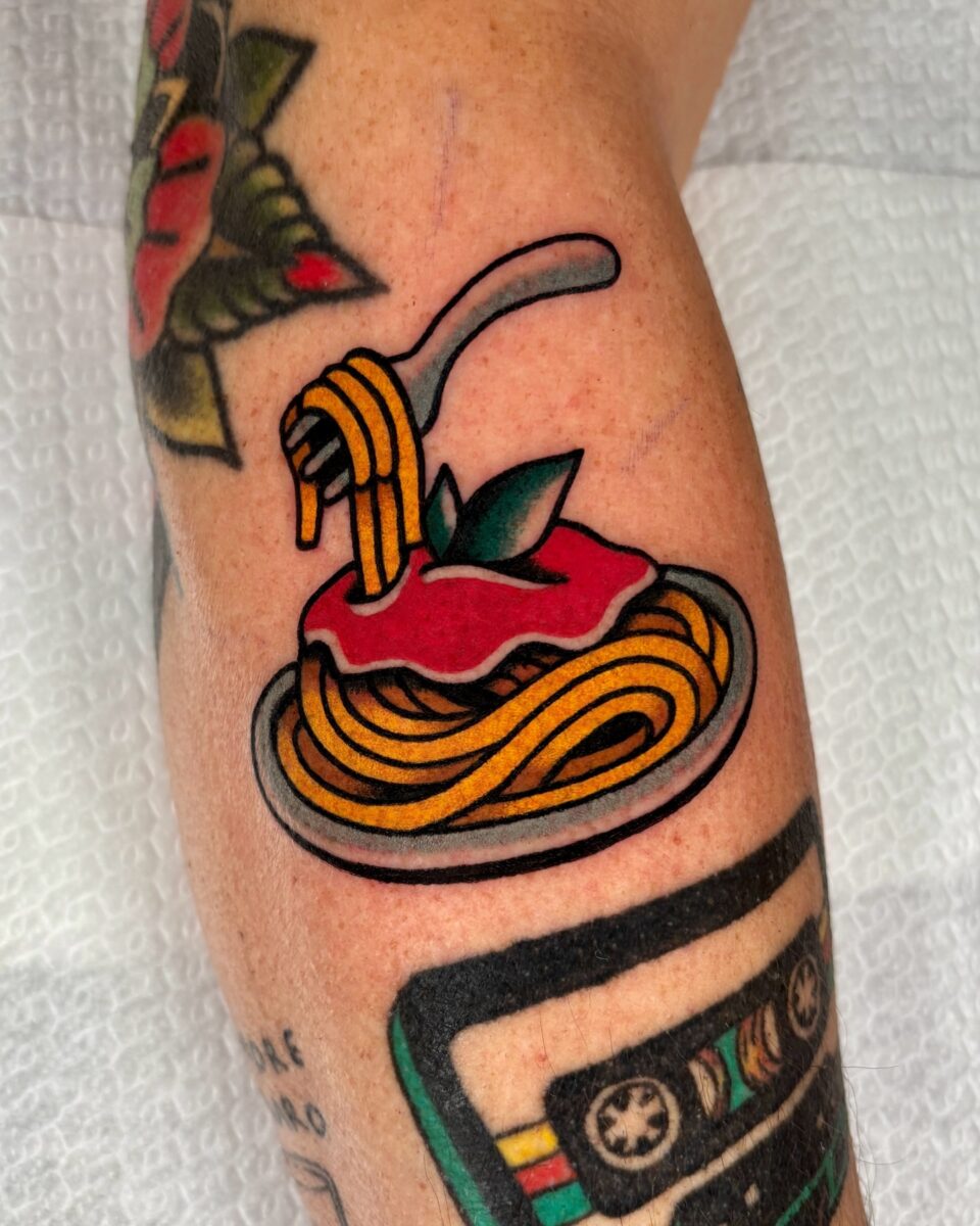 Vibrant spaghetti tattoo with playful details