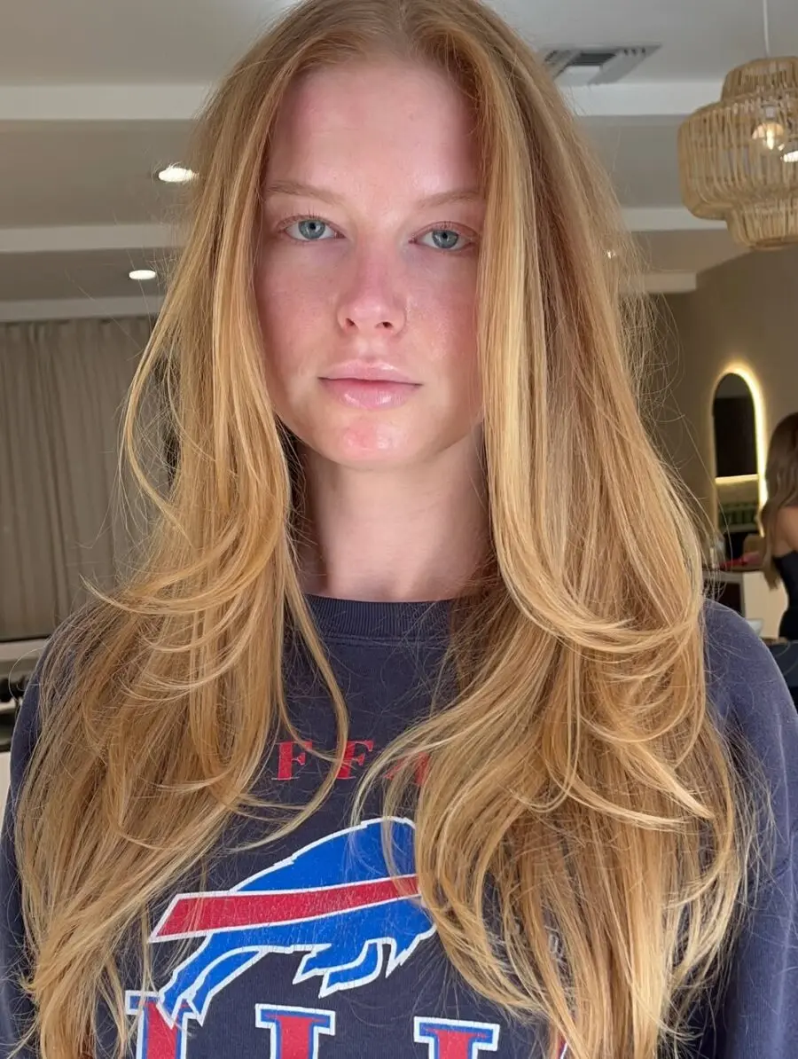 Elegant long strawberry blonde hairstyle with layers