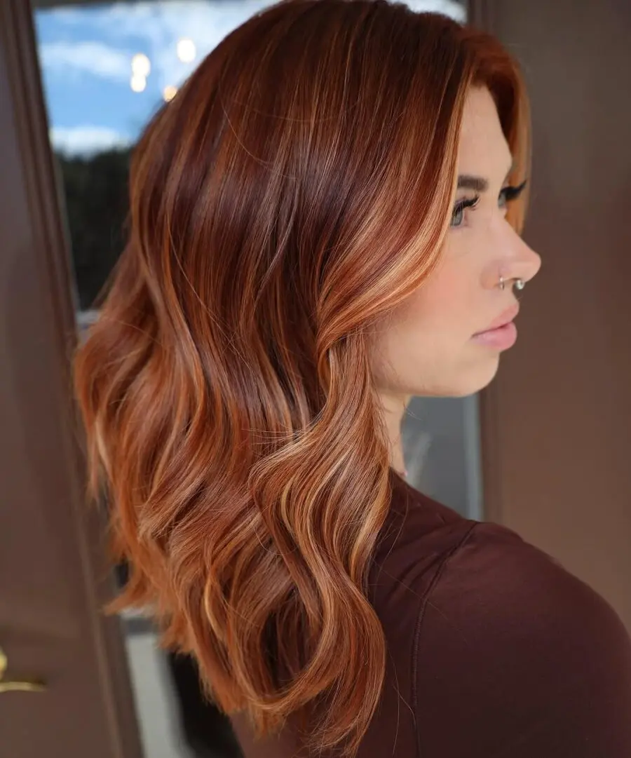 Wavy strawberry blonde with sun-kissed highlights