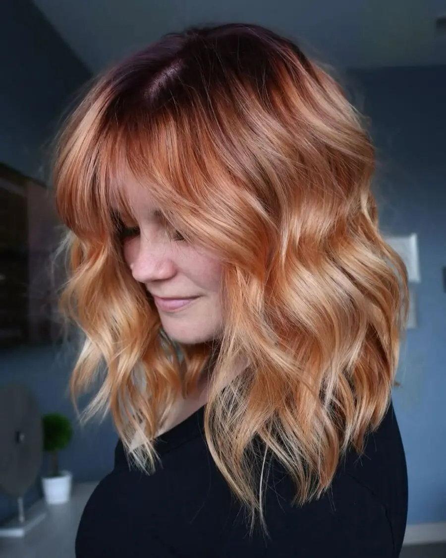Wavy Strawberry Blonde Bob with Playful Bangs