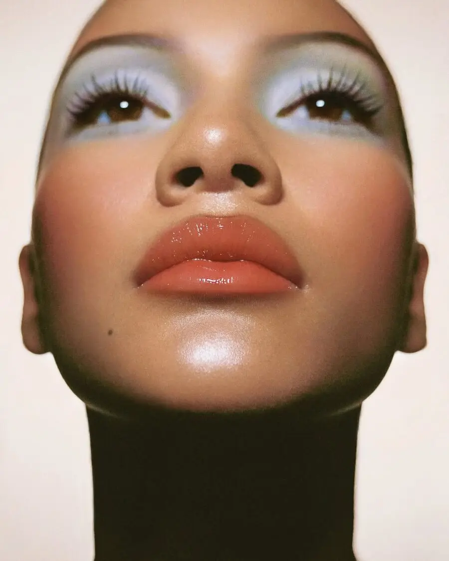 Glossy coral lipstick perfect for summer vibes
