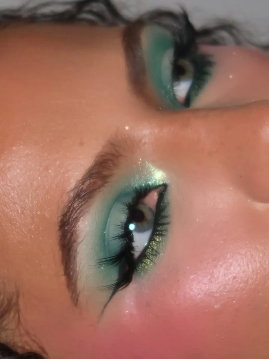 Vibrant green eyeshadow with sparkling highlights
