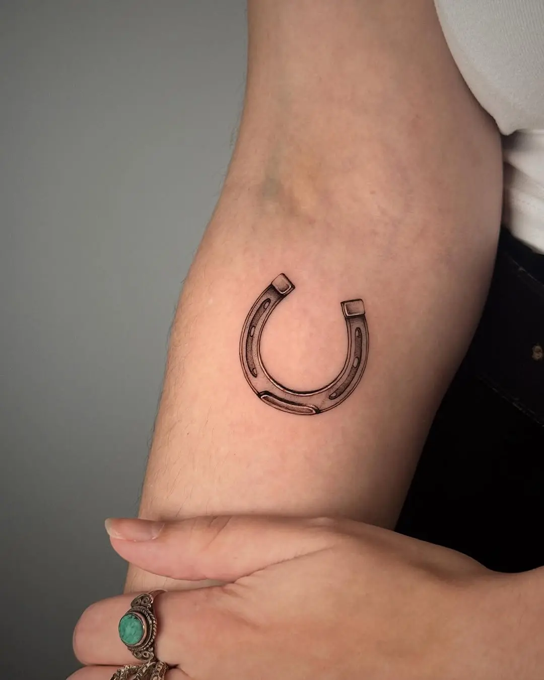 Stylish horseshoe tattoo on the arm