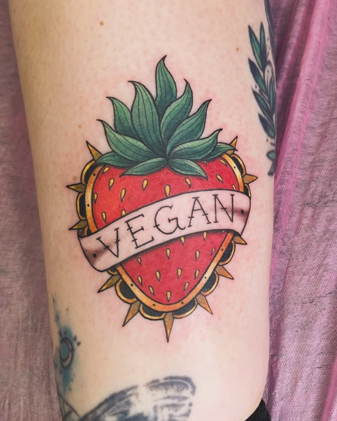 Vibrant vegan tattoo with a strawberry motif