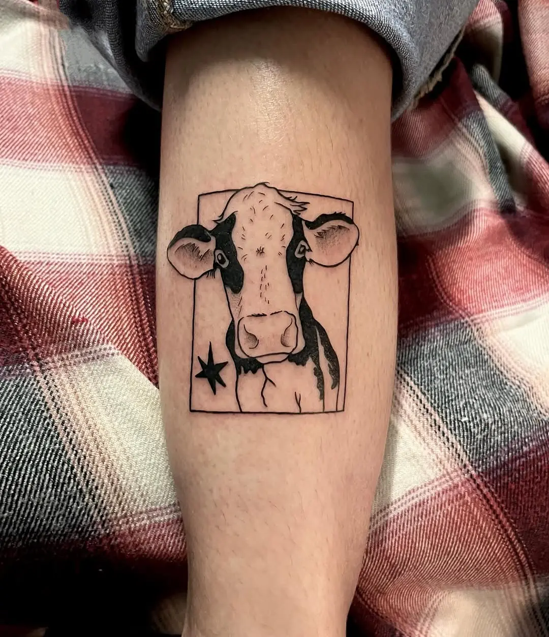 Charming cow tattoo with artistic flair