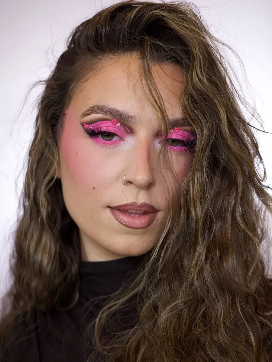 Bold pink eyeshadow with textured curls