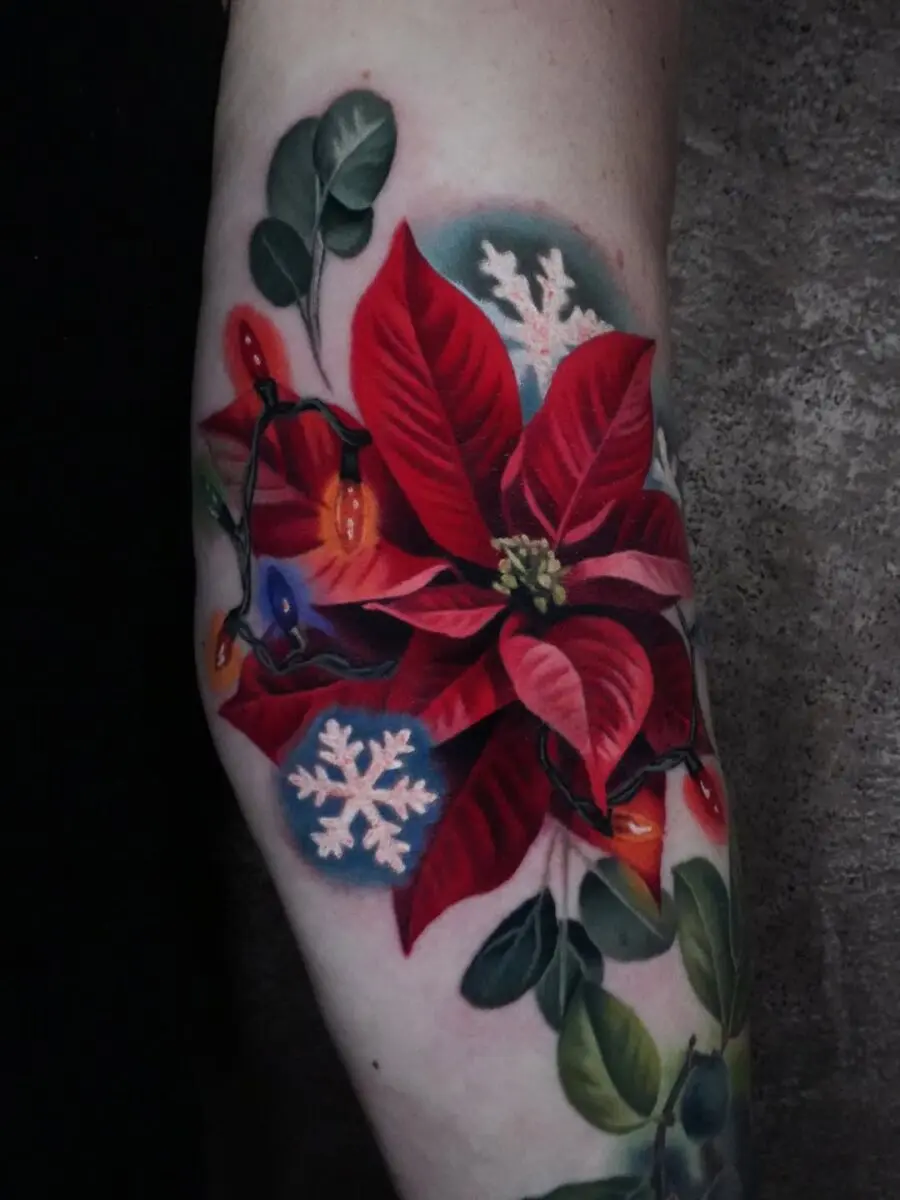 Vibrant poinsettia tattoo with festive details