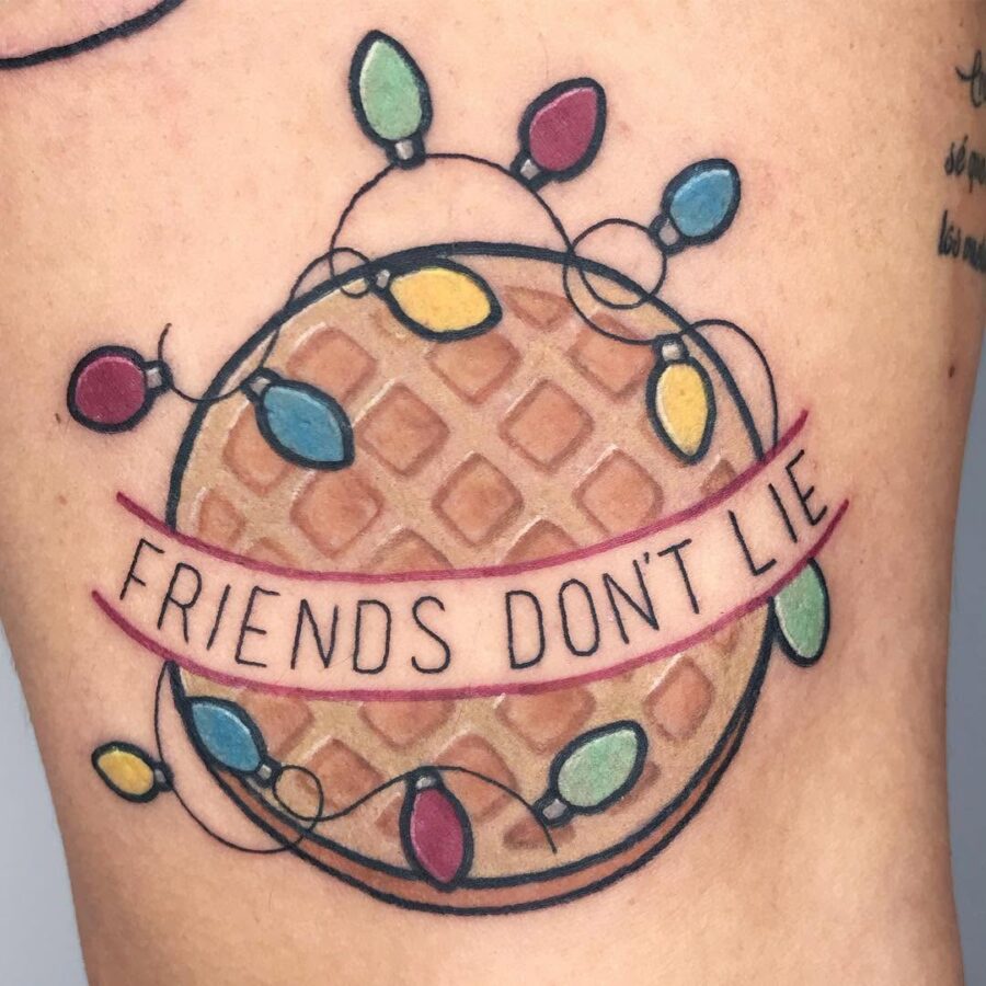Waffle tattoo with festive lights and text