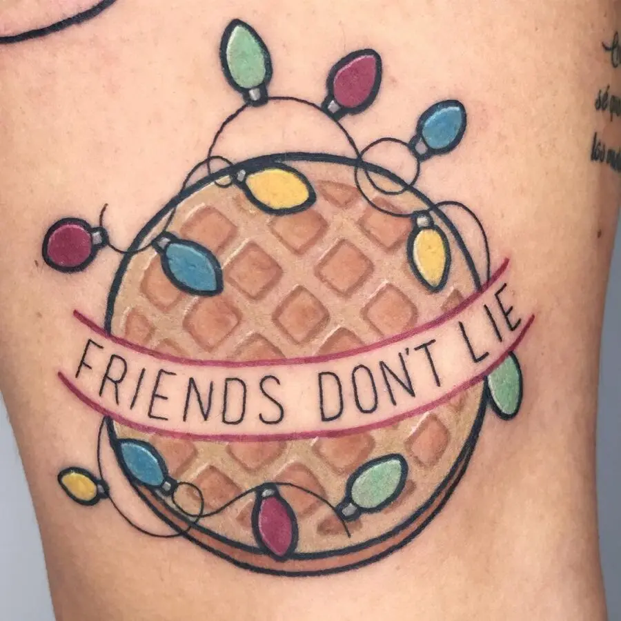 Waffle tattoo with festive lights and text