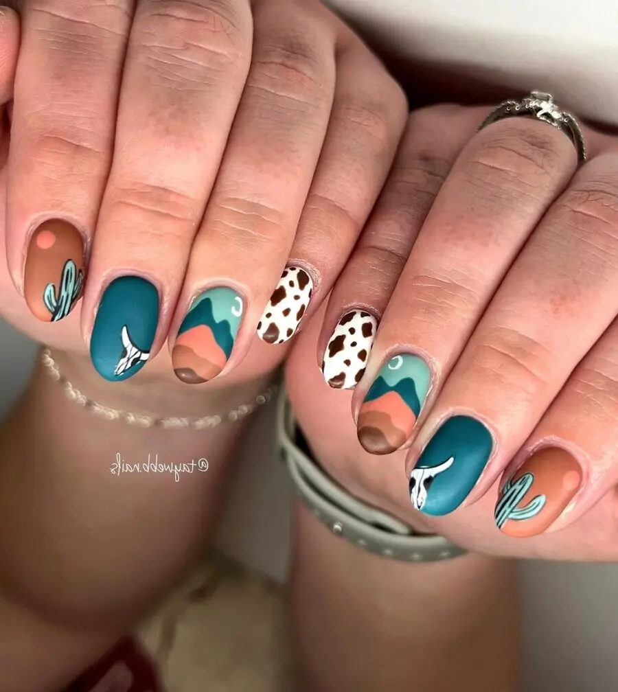 Colorful western-themed nails with desert vibes