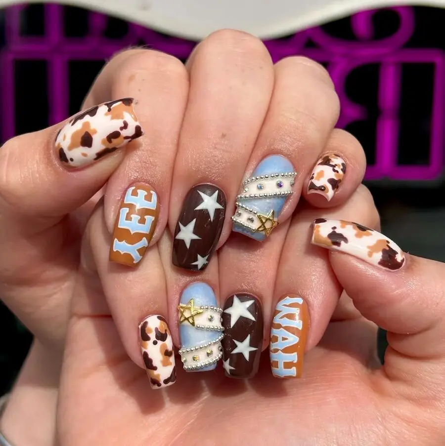 Stylish Western-themed nail art with cow print