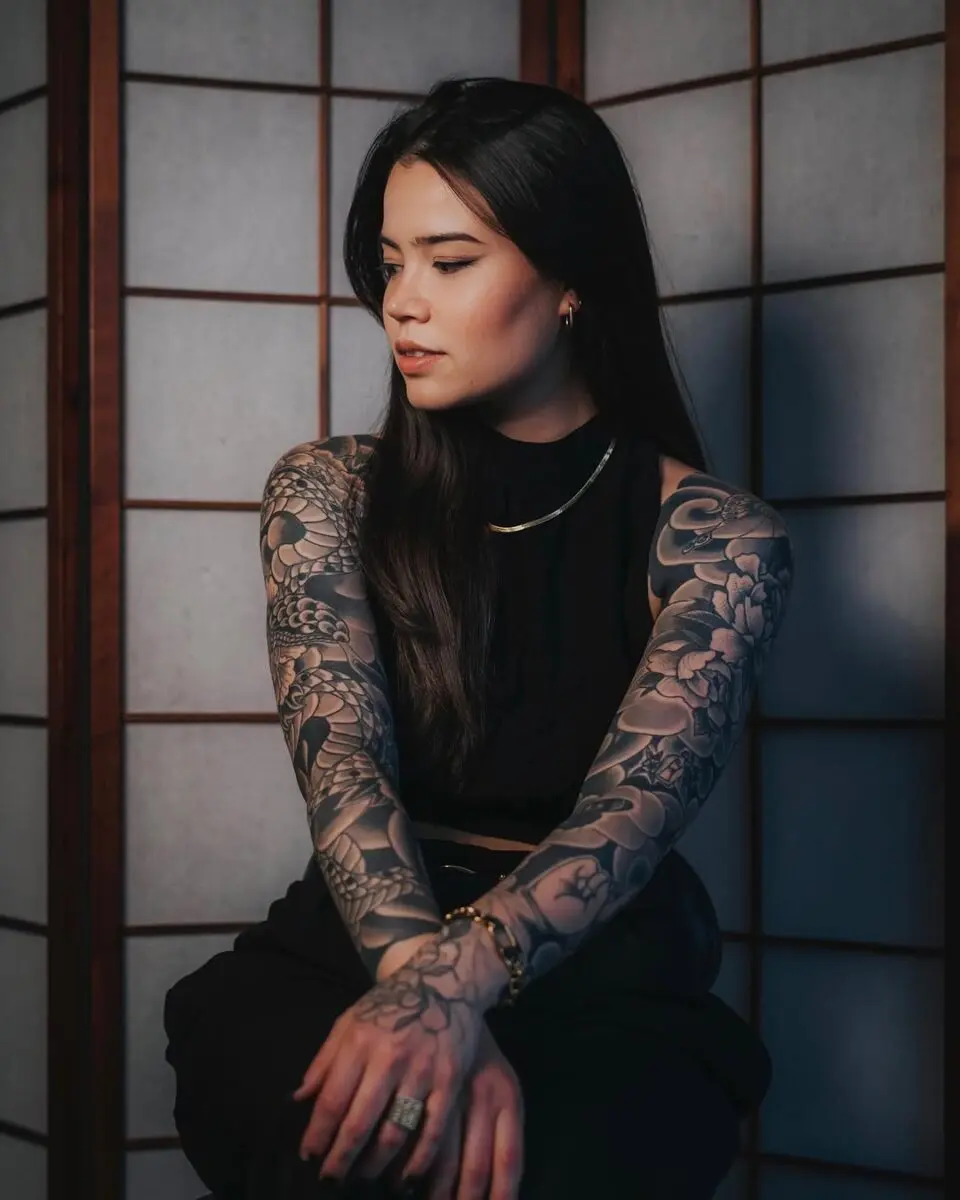 Intricate yakuza tattoos adorning elegant arms