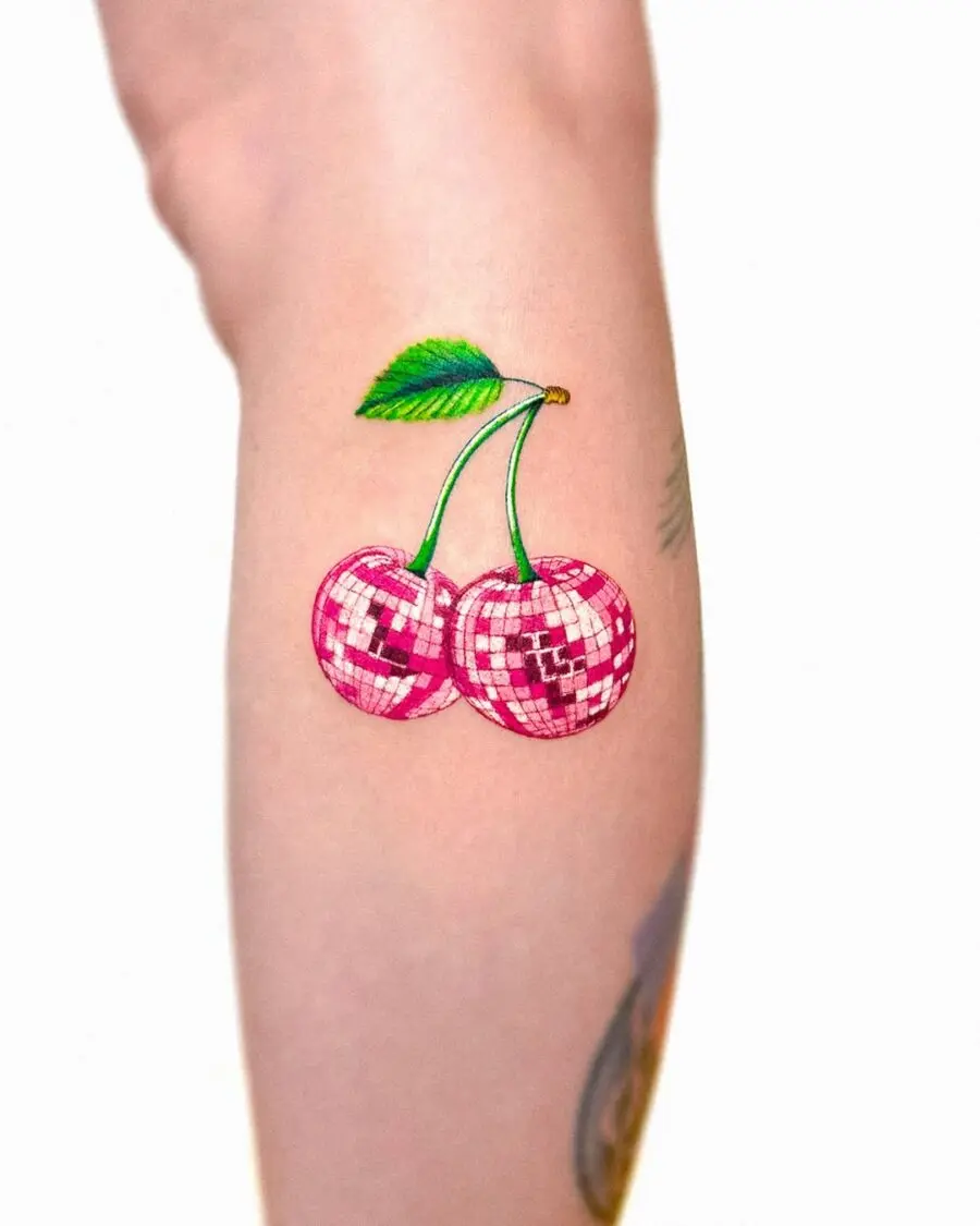 Vibrant Cherry Tattoo with Disco Vibes