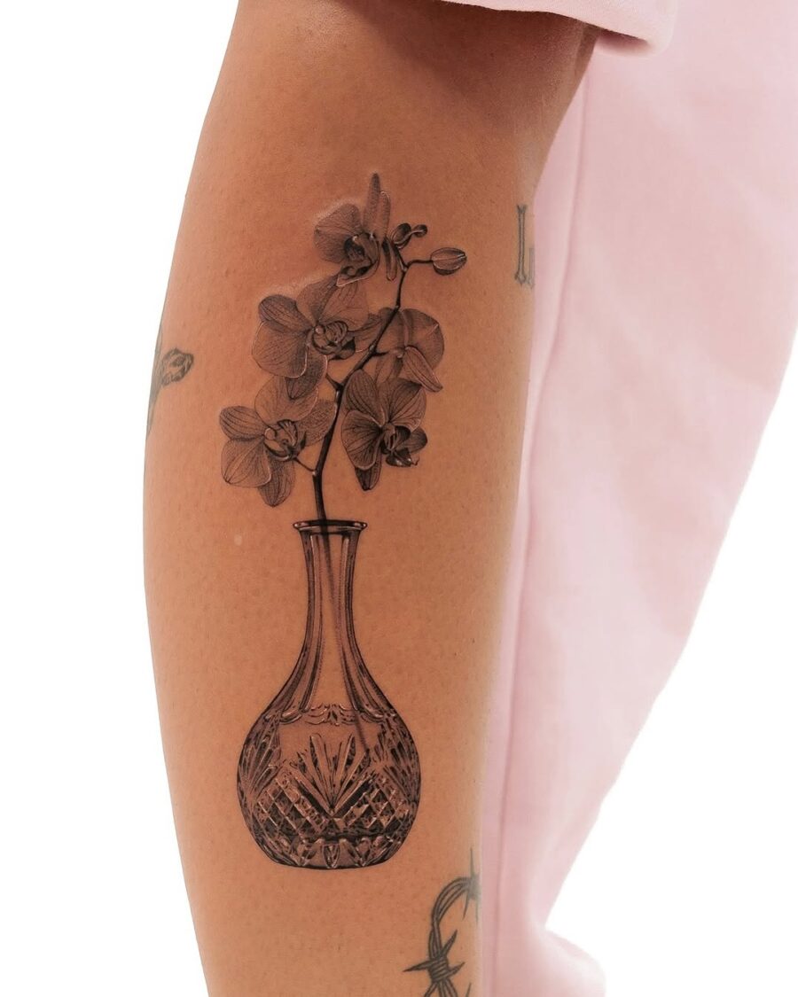 Elegant floral vase tattoo with delicate details