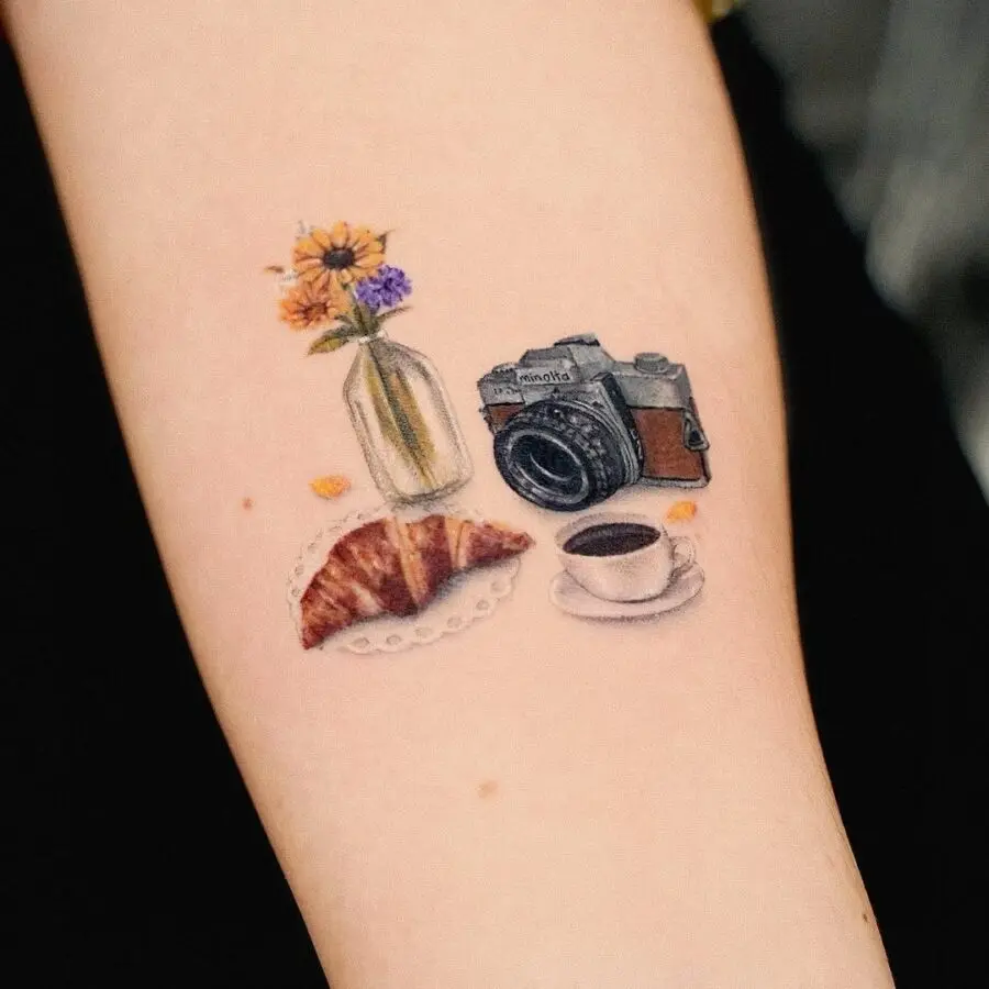 Whimsical tattoo featuring food and photography elements