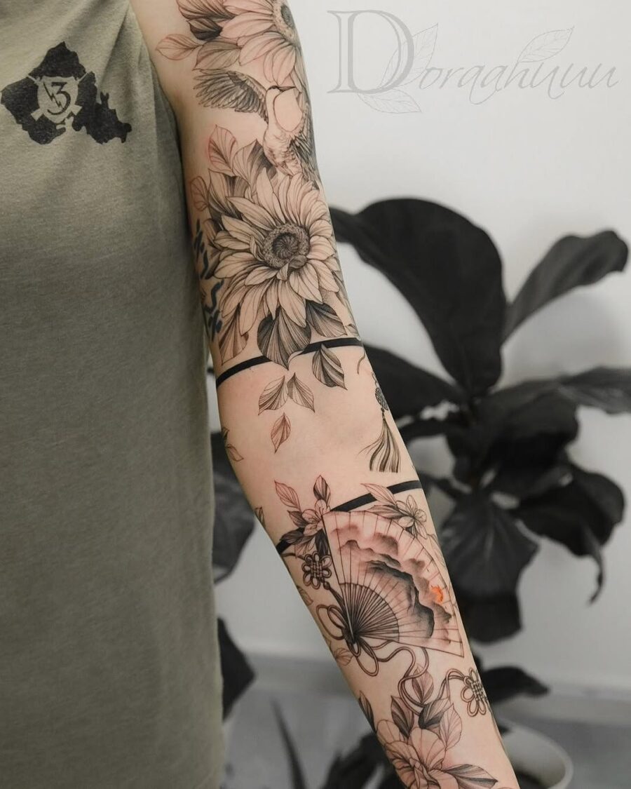 Intricate floral sleeve tattoo with elegant fan