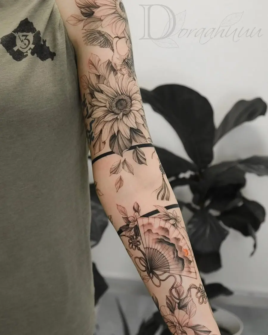 Intricate floral sleeve tattoo with elegant fan