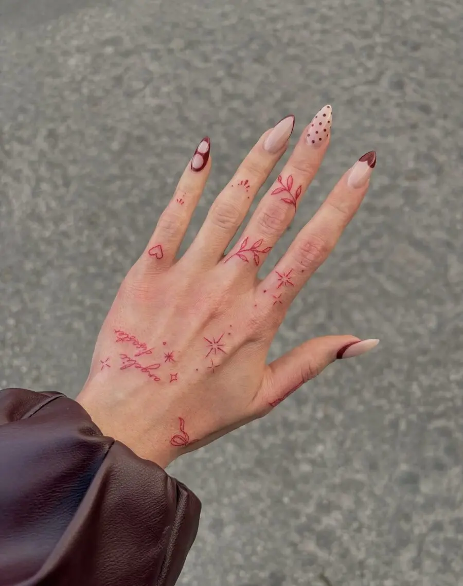 Delicate floral aesthetic on vibrant hand tattoos