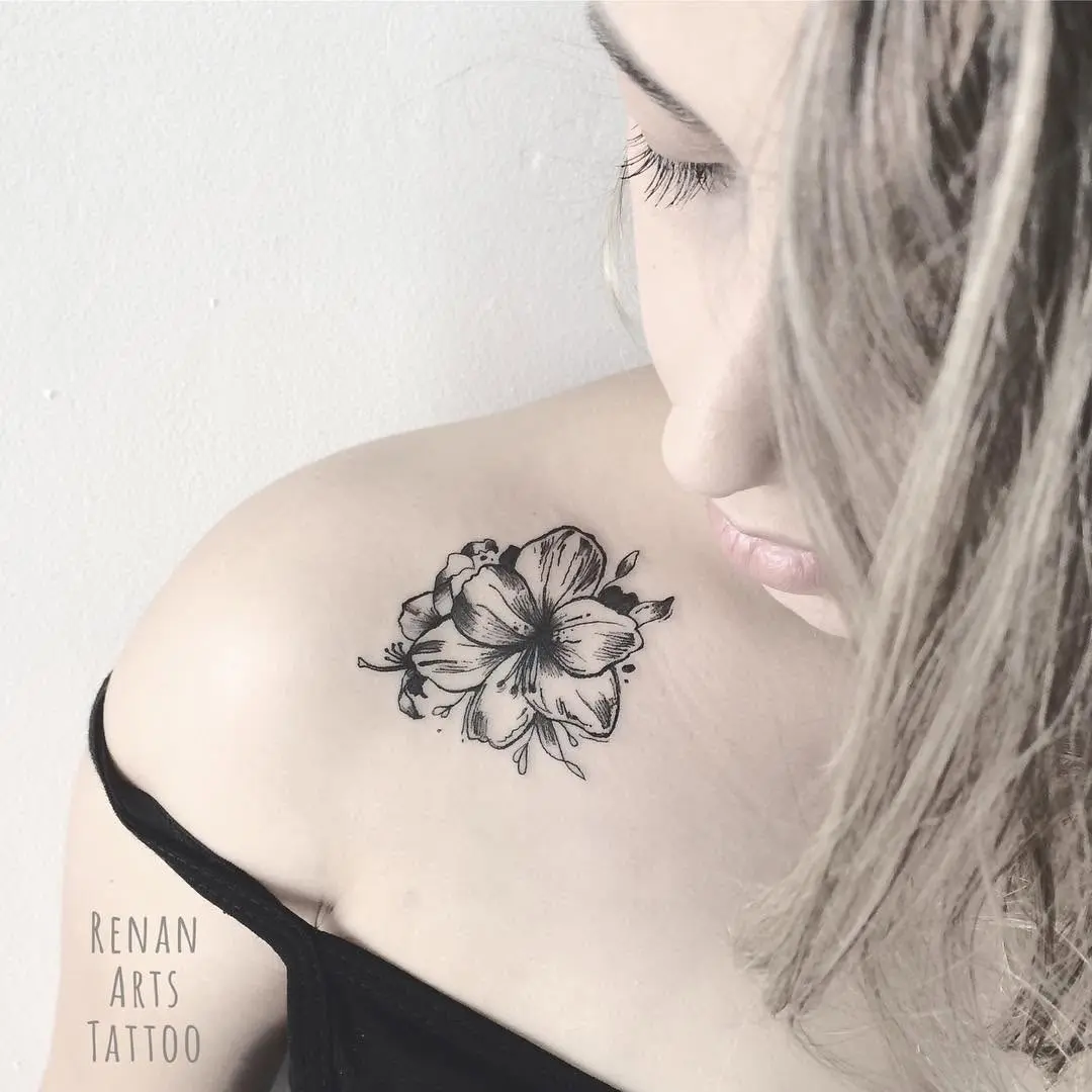 Elegant amaryllis flower tattoo on shoulder