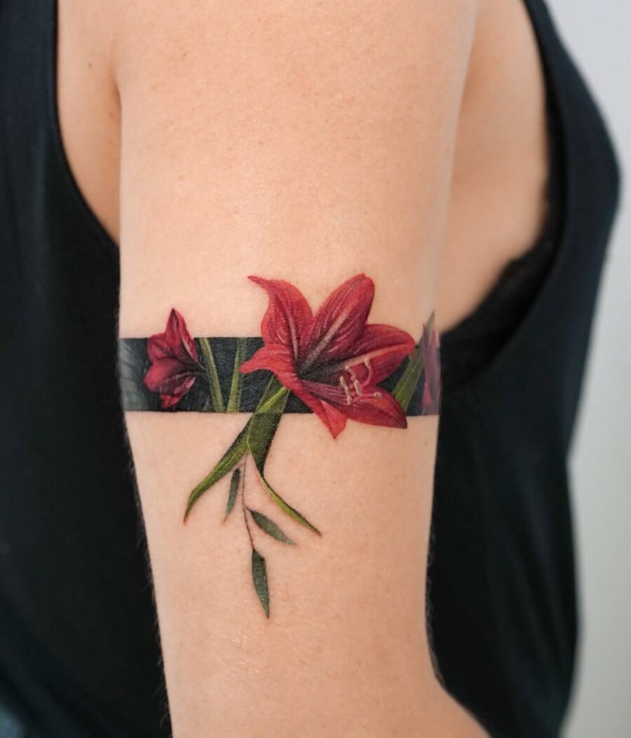Vibrant amaryllis flower tattoo on arm